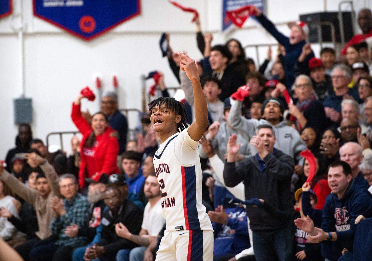 Modesto Christian’s Zeke Davis signals three after scoring a three point bucket during the NorCal Open Division semifinal playoff game with De La Salle in Salida, Calif., Saturday, March 4, 2023. Modesto Christian won the game 57-56.