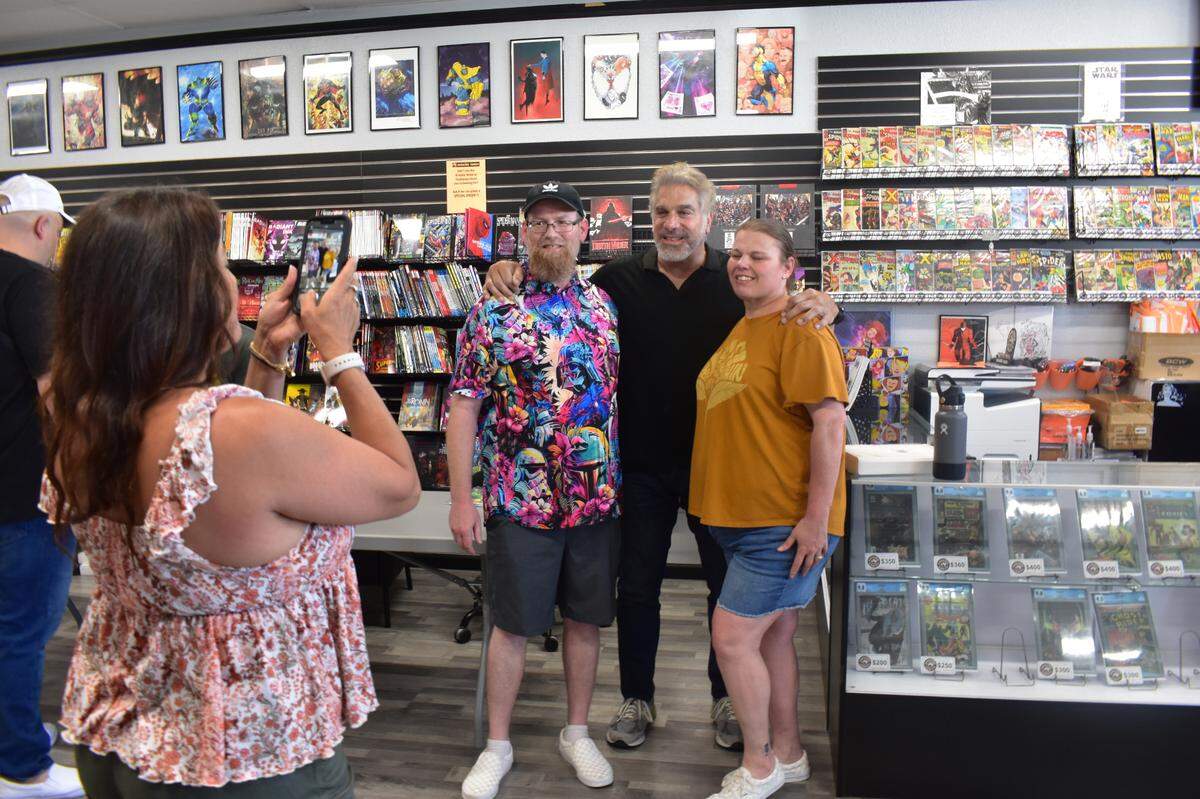 Eager fans take photos with The Incredible Hulk star Lou Ferrigno at Invincible Comics in Modesto on Friday, June 7.