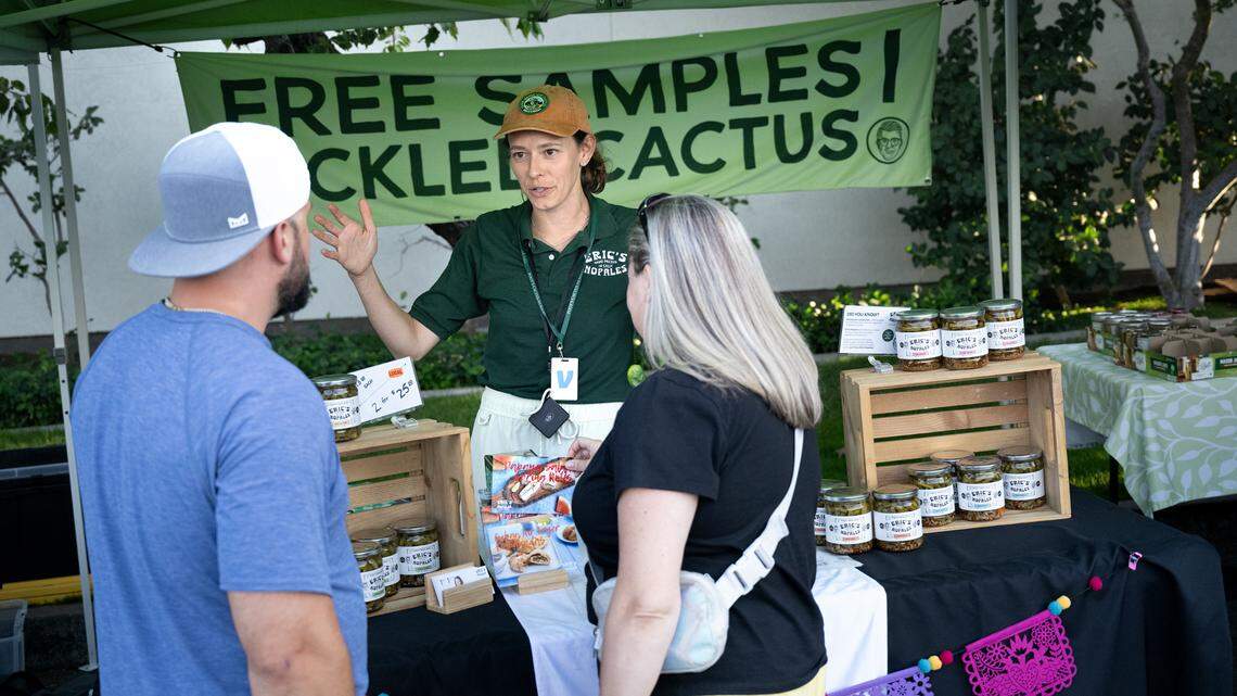 Jillian Ruiz talks with friends as she sells pickled nopales (Eric’s Nopales) at the Ripon Farmers Market in Ripon, Calif., Thursday, Sept. 19, 2024. Ruiz and her husband Eric created a line of pickled nopales cactus.