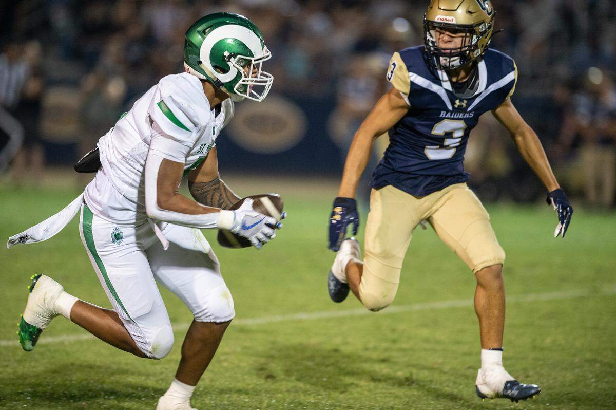 St. Mary’s Naseri Danielson makes a catch as Central Catholic’s Trace Hernandez defends during the non-league game at Central Catholic High School in Modesto, Calif., on Friday, September 2, 2022.