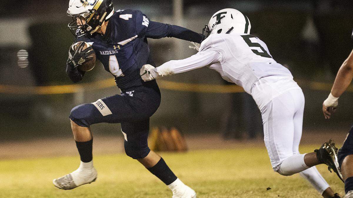 Central Catholic’s Julian Lopez breaks a tackle on a touchdown run during the the first round CIF Sac-Joaquin Section Division II playoff game with Tracy at Central Catholic High School in Modesto, Calif., Friday, Nov. 8, 2019. Central Catholic won the game 58-14.