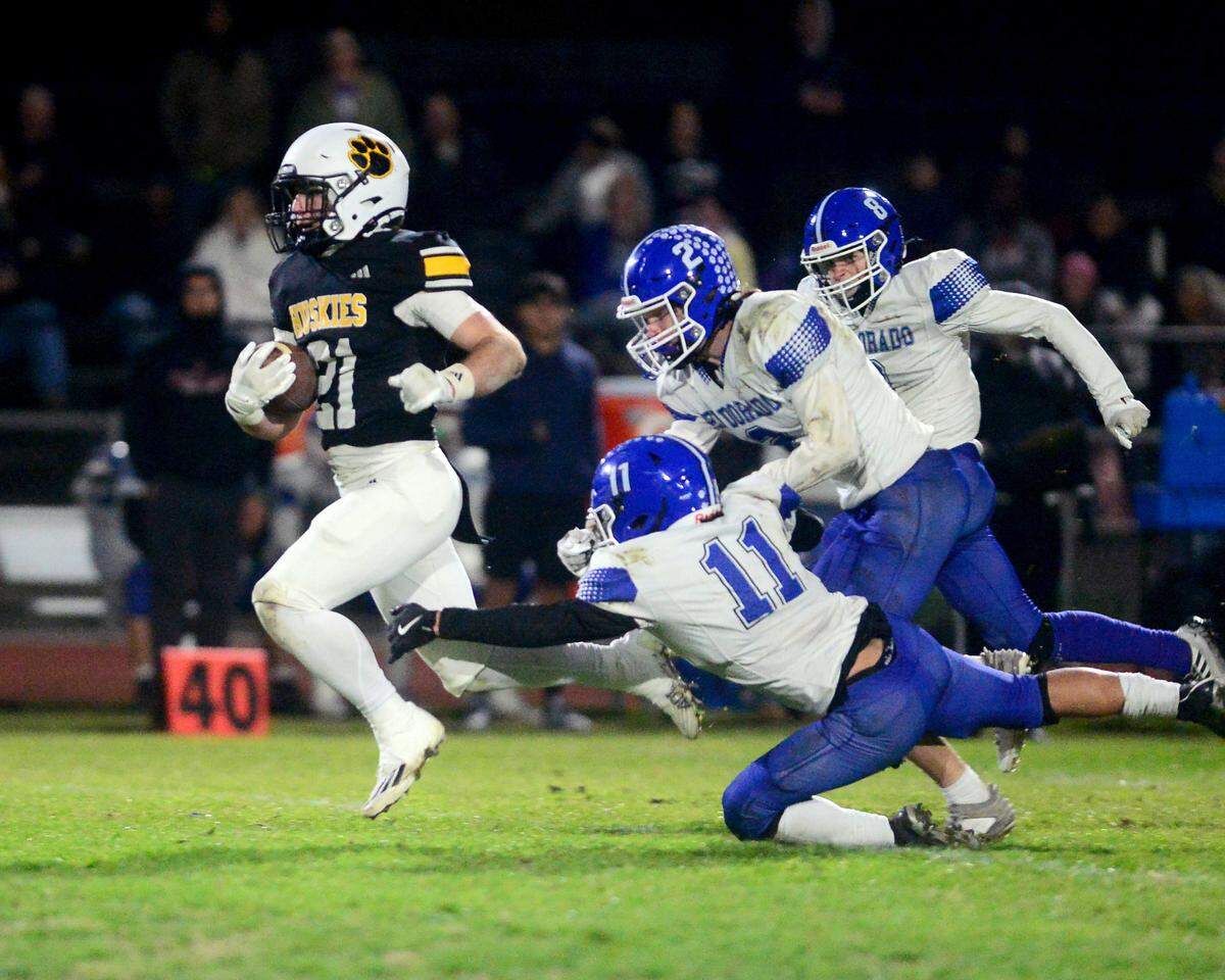 Hughson running back Eli Wilbanks (21) breaks free on a run during a 2024 CIF Sac-Joaquin Section Division V Playoff game between Hughson High School and El Dorado High School at Hughson High School in Hughson California on November 15, 2024. Hughson won the game 28-6.
