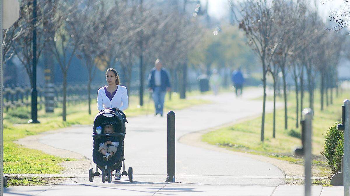 Babysitter Chelsea Watkins pushes young Cooper along the Virginia corridor walking path from a stroller in 2013.