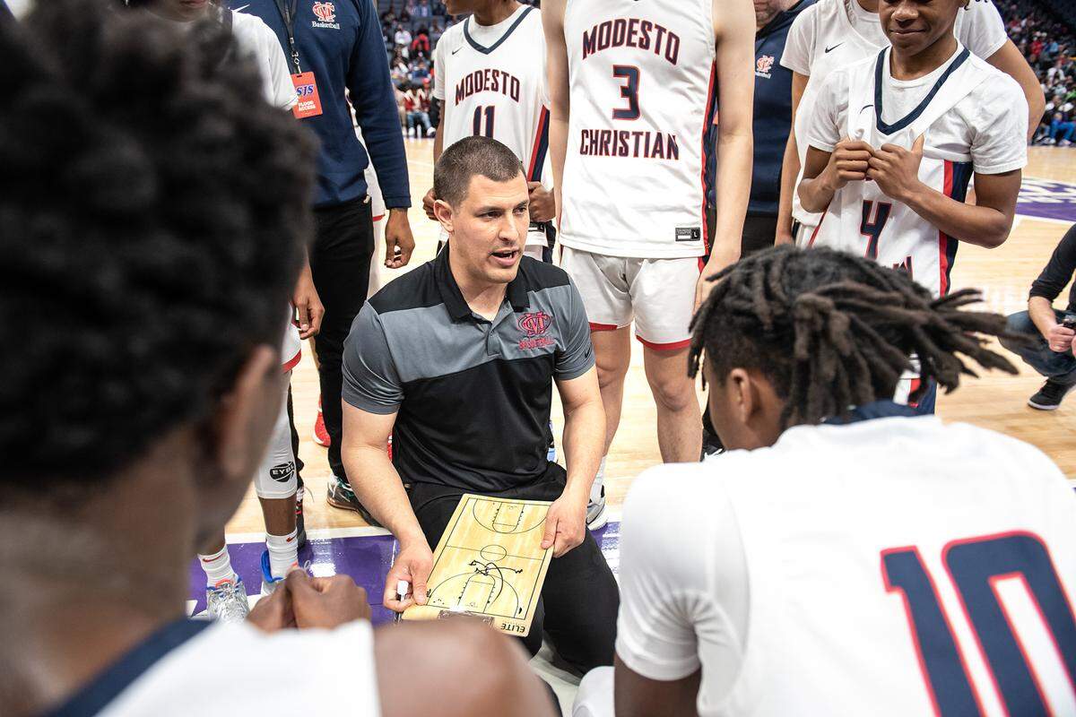 Modesto Christian coach Brice Fantazia sketches out a play during a timeout during the Sac-Joaquin Section Division 1 boys basketball championship game with Sheldon at the Golden 1 Center in Sacramento, Calif., on Saturday, Feb. 26, 2022. Modesto Christian won the game 52-42.