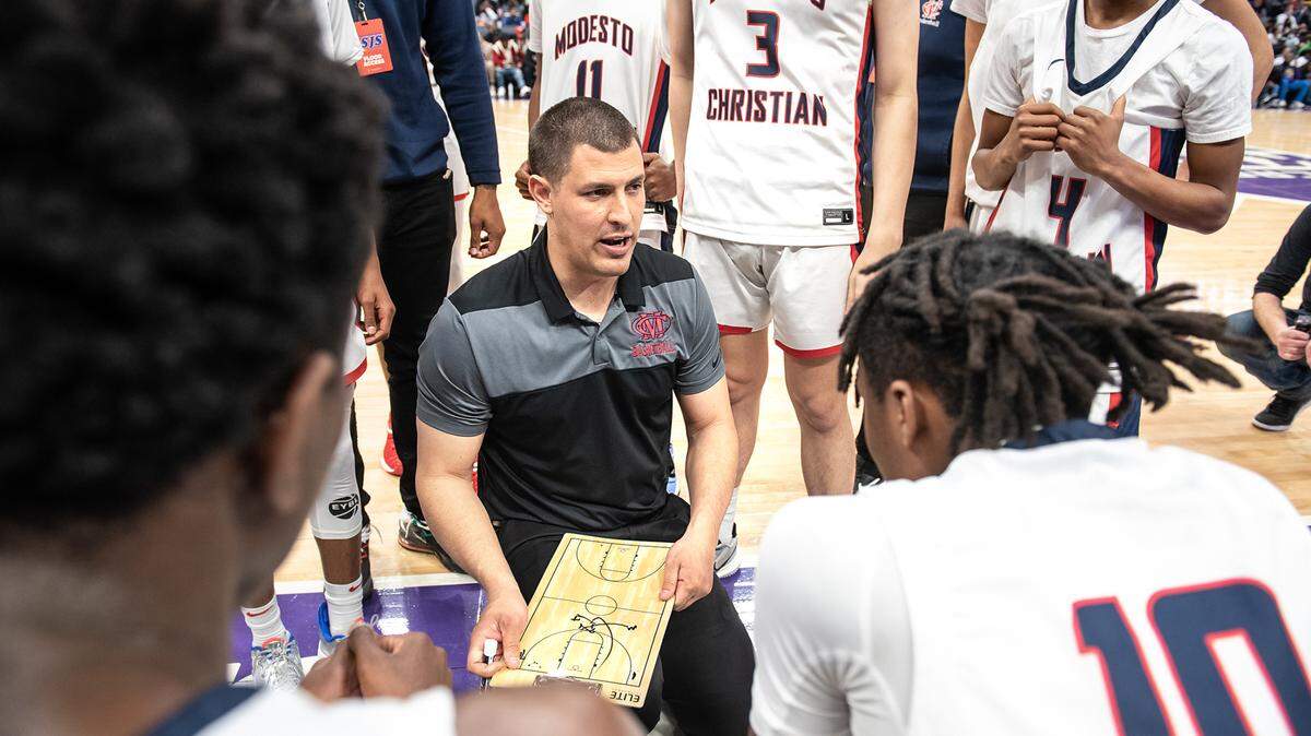 Modesto Christian coach Brice Fantazia sketches out a play during a timeout during the Sac-Joaquin Section Division 1 boys basketball championship game with Sheldon at the Golden 1 Center in Sacramento, Calif., on Saturday, Feb. 26, 2022. Modesto Christian won the game 52-42.