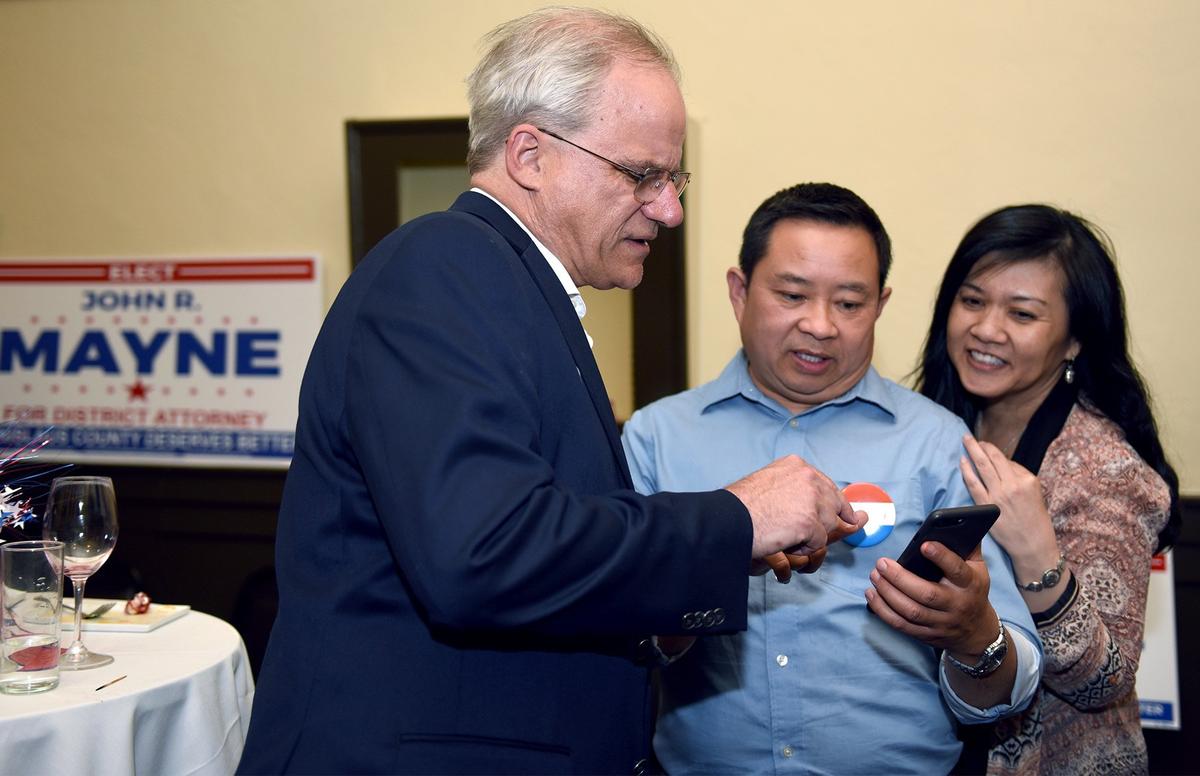 Stanislaus County Deputy District Attorney John R. Mayne is pictured Tuesday evening June 5, 2018 looking at election results with Kevin Panyanouvong and Cam Quach (right) at Concetta in downtown Modesto, Calif.