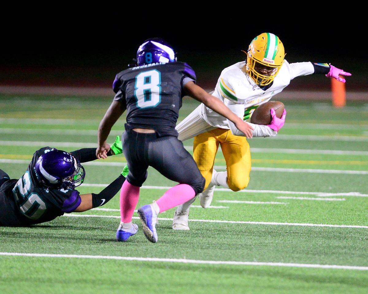Davis receiver Johan Chaney (0) gets dragged down by a Johansen defender during a game between Johansen and Davis at Johansen High School in Modesto California on November 1, 2024.