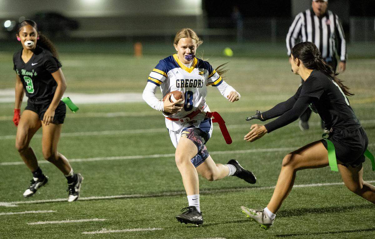 Gregori quarterback Audrey Pacheco runs the ball as St. Mary’s Ava Gonzales defends during the Sac-Joaquin Section playoff game at St. Mary’s High School in Stockton, Tuesday, Oct. 29, 2024. St. Mary’s won the game 46-36.