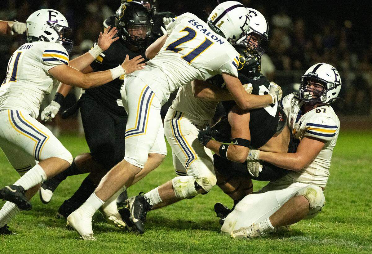 Escalon defenders sack Hughson quarterback Robert Mcdaniel during the Trans Valley League game in Hughson, Calif., Friday, Oct. 4, 2024.
