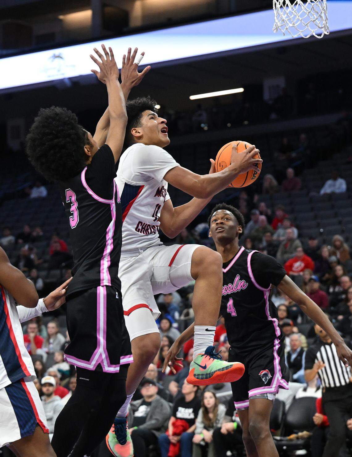 Modesto Christian’s Gavin Sykes scores on a drive to the basket during the Sac-Joaquin Section Division I championship game with Lincoln of Stockton at the Golden 1 Center in Sacramento, Calif., Wednesday, Feb. 21, 2024. Sykes scored 16 points in the game.