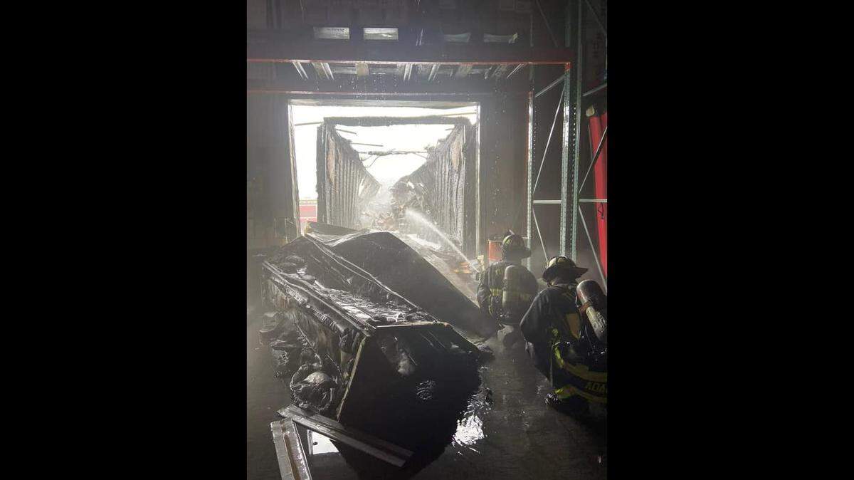 Fire crews respond to a blaze at Northern Refrigerated Transportation in Turlock, Calif., on March 27, 2022.