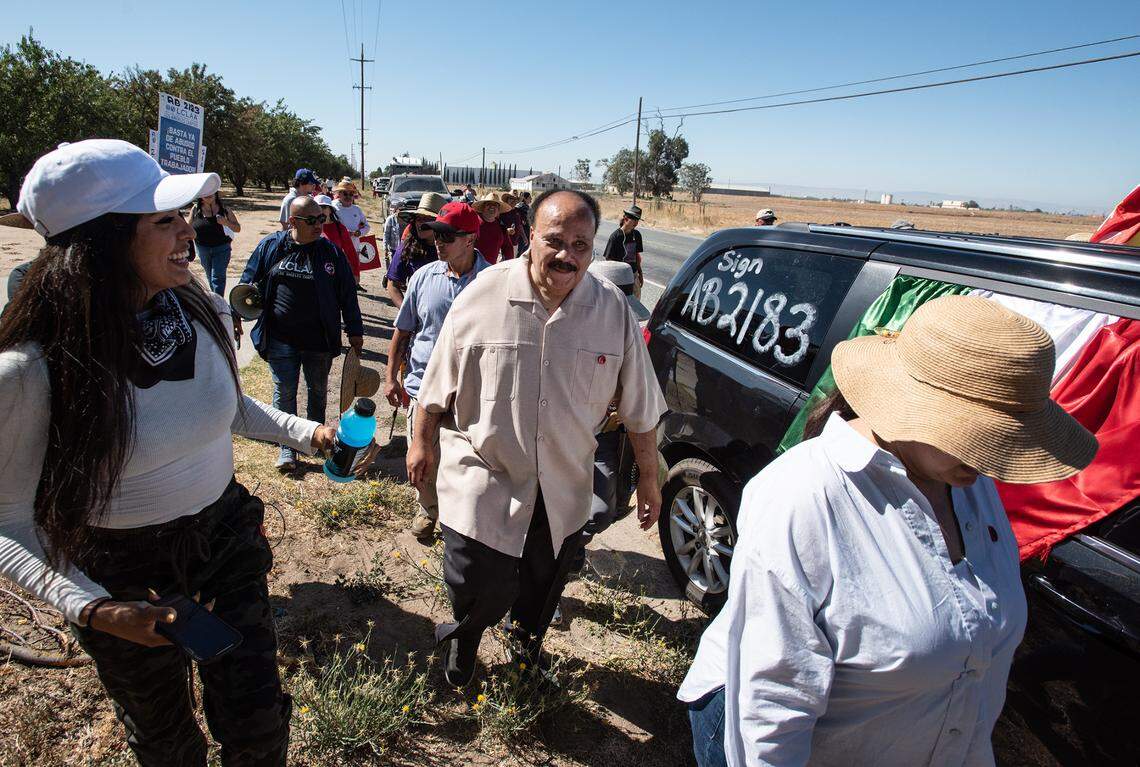 Martin Luther King III, middle, walks with members of United Farm Workers and its supporters in Manteca, Calif., on August 20, 2022. King joined the UFW for part of one leg of the 24-day “March for the Governor’s Signature”, a 335 mile trek from Delano to Sacramento that began on August 3. The union hopes Gov. Gavin Newsom will sign Assembly Bill 2183 that would amend the California Labor Code to allow farmworkers to vote by mail or by dropping off their ballots at designated locations.
