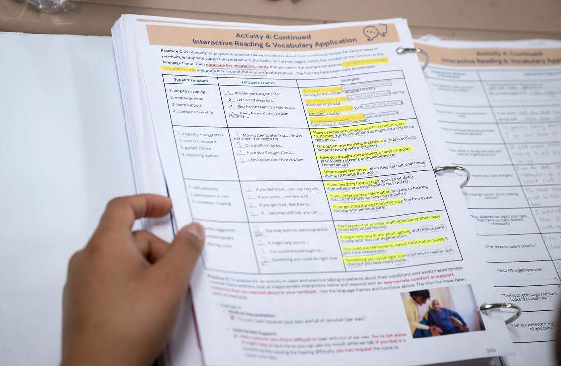 Hangama Amirpoor looks through her notes during an English language class for nursing assistant students at Modesto Junior College in Modesto, Wednesday, Nov. 26, 2025.