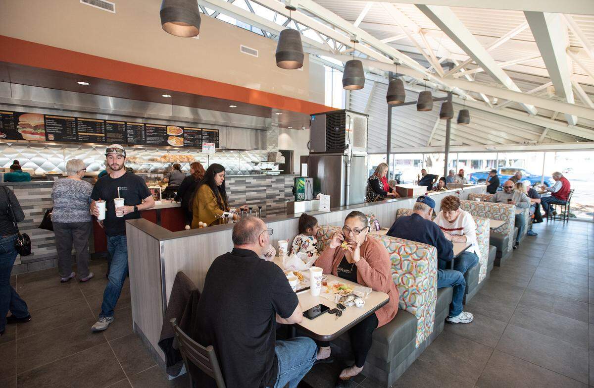 Customers eat lunch at Nation’s Giant Hamburgers on McHenry Avenue, including Freddy and Betsy Huss, front, in Modesto, Calif., Wednesday, Nov.16, 2022.