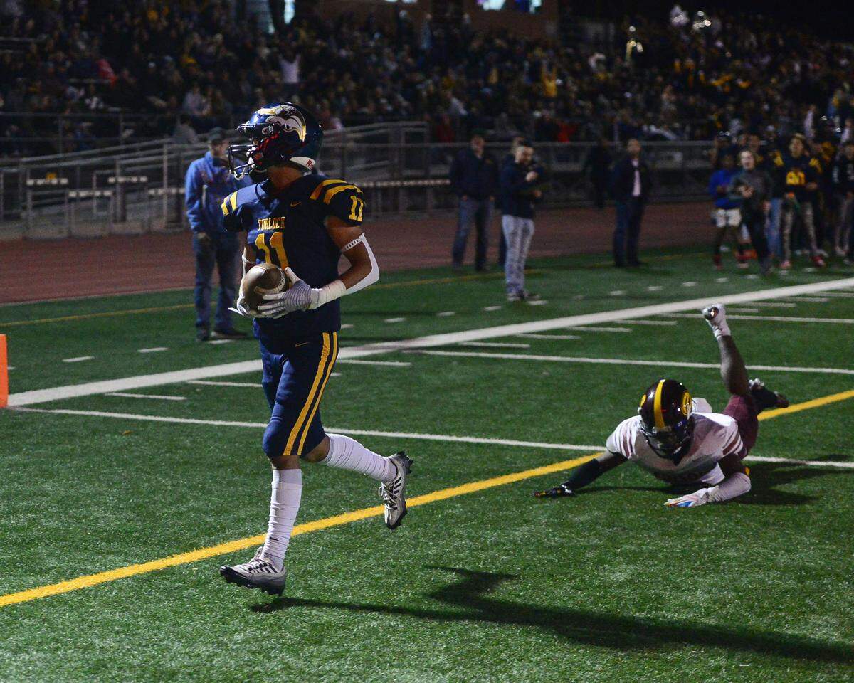 Turlock receiver Jeremiah Bertalotto (11) looks back after scoring a touchdown during a CIF Division I CIF Sac-Joaquin Section Football Playoff game between Turlock High School and Edison High School at Turlock High School in Turlock CA on November 4, 2022. Turlock won 35-0.