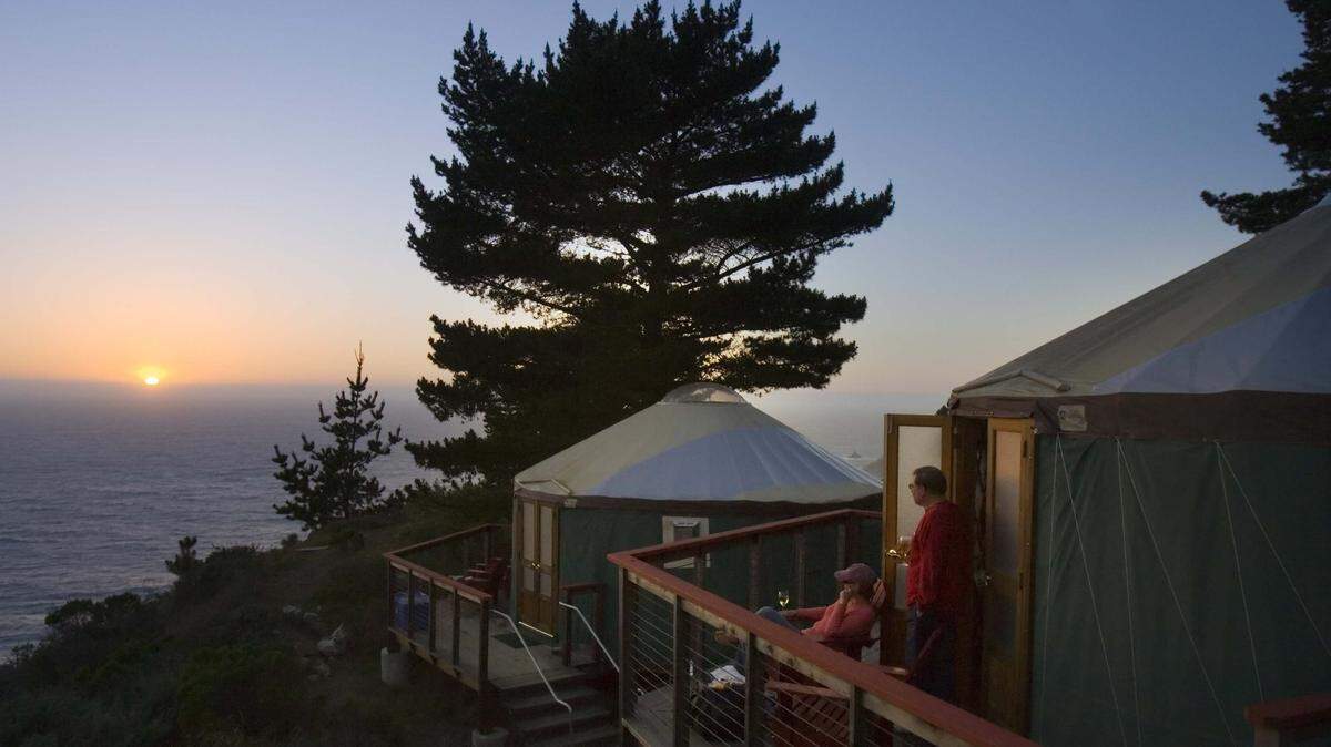 Guests at Treebones Resort, at the southern end of Big Sur and a scenic drive north from Hearst Castle, enjoy the sunset over the Pacific Ocean from the comfort of their yurt.