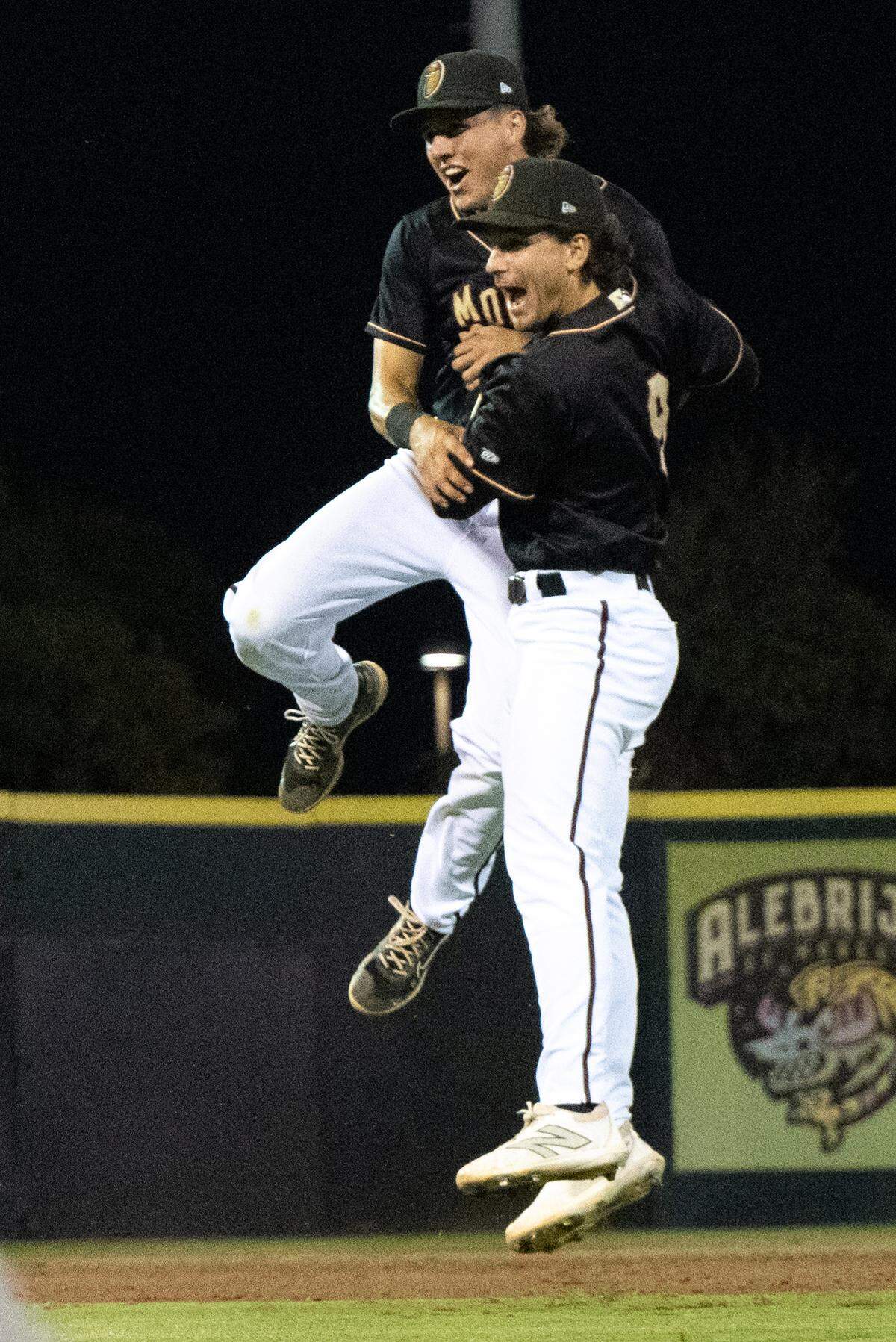 Modesto’s Charlie Pagliarini and Carter Dorighi celebrate the California League Championship title victory over Lake Elsinore at John Thurman Field in Modesto, Calif., Wednesday, Sept. 18, 2024.