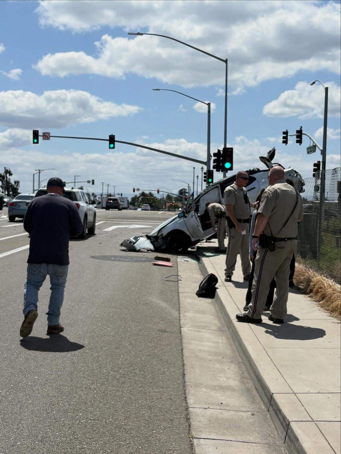California Highway Patrol officers investigate a rollover crash at the Highway 99 and Highway 219 interchange Monday afternoon. Authorities said the driver is expected to face a reckless driving charge.