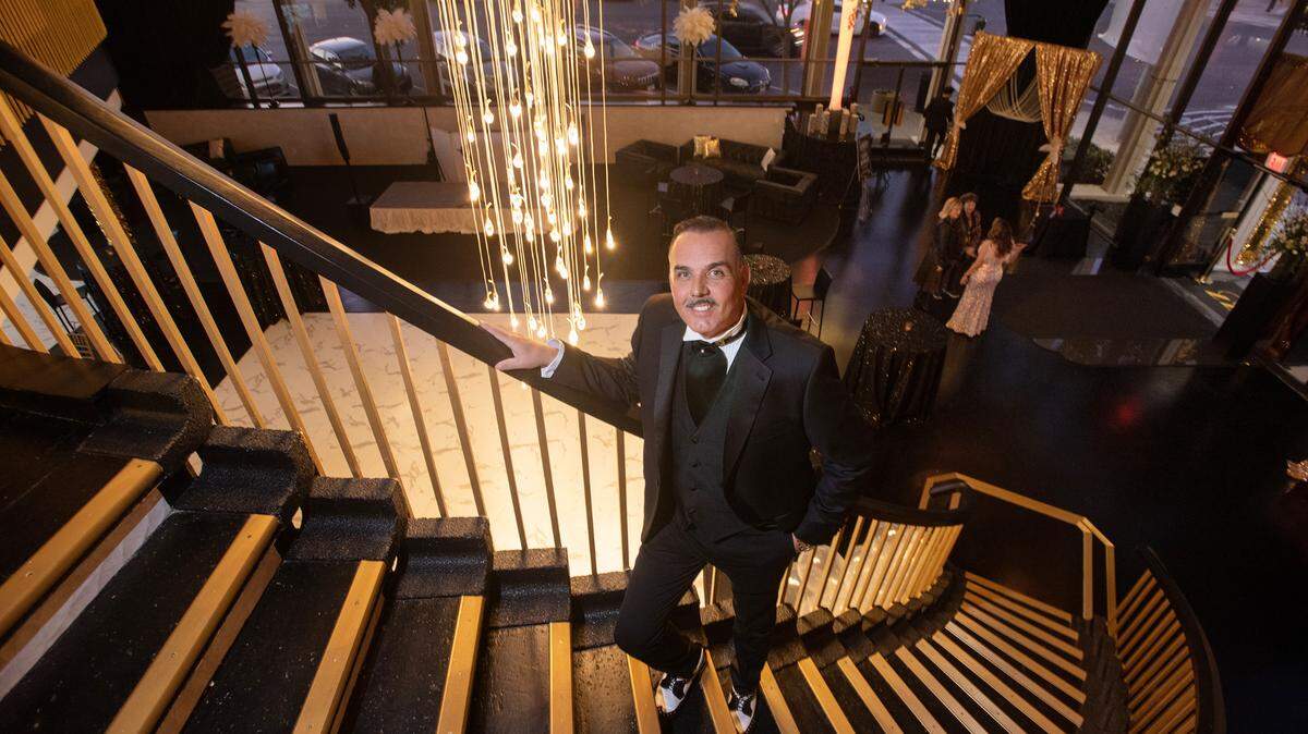 Building owner Jaime Jimenez stands on the grand staircase at Venue 833 in Modesto, Calif., on Friday, Feb. 4, 2022.
