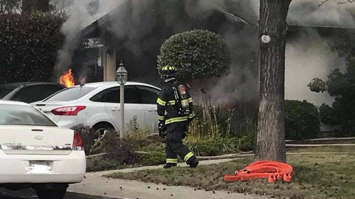 Firefighters attack a fire at a house in the 2700 block of Chapparal Place in Modesto, California on Sunday afternoon (Jan. 14, 2018).