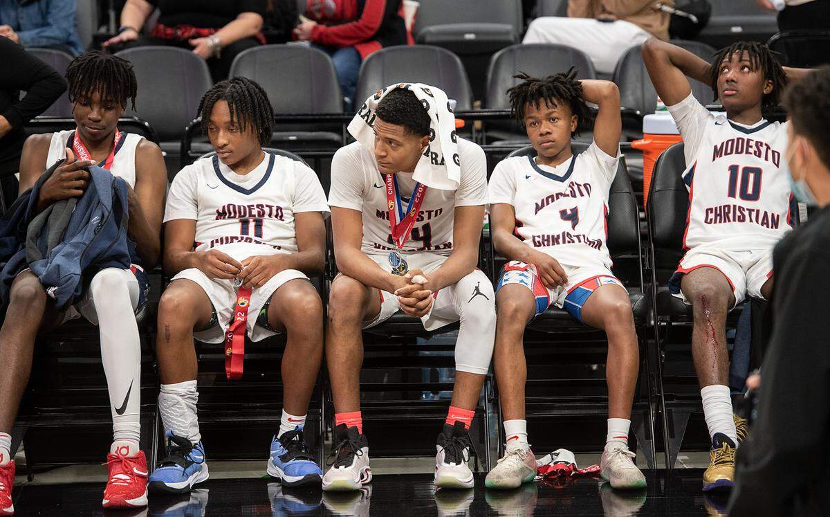 Modesto Christian players sit on the bench after their 59-50 loss to Centennial in the boys Open Division CIF State Basketball Championship game at Golden 1 Center in Sacramento, Calif., on Saturday, March 12, 2022.