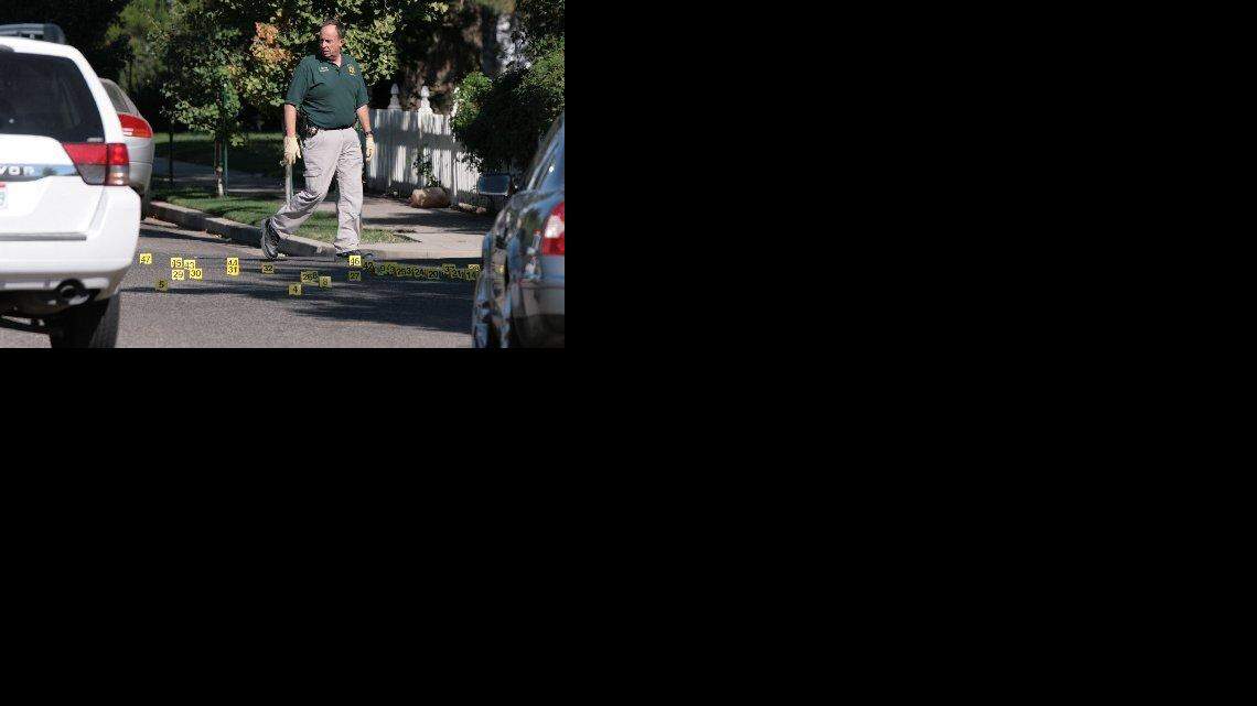 VISALIA, CA. 8/29/10 A Visalia Police detective walks from a marked area where a suspect was shot after the bishop of the Mormon Church was shot and killed Sunday, Aug. 29, 2010 in Visalia, Calif. GARY KAZANJIAN/THE FRESNO BEE