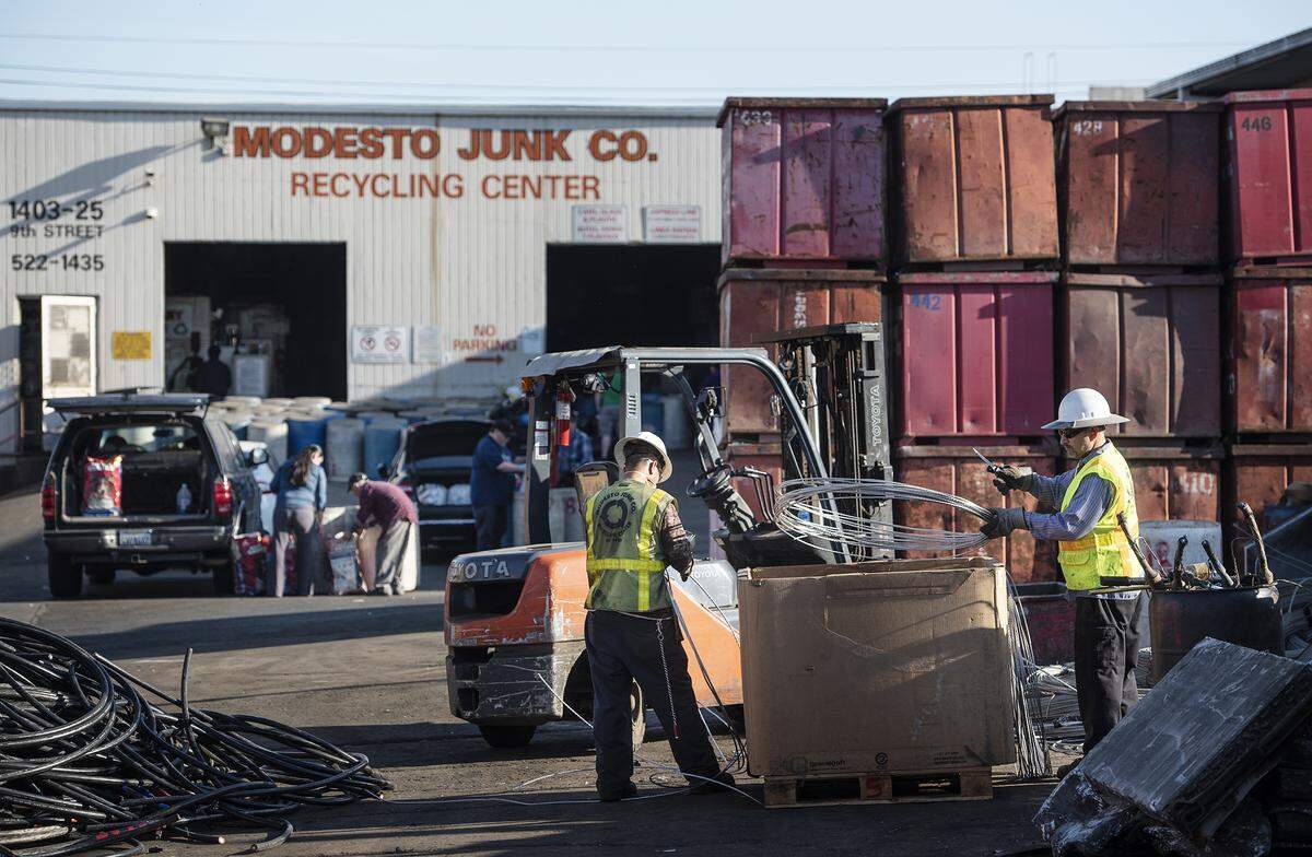 Workers sort metal wire at Modesto Junk Co. in Modesto, Calif., on Wednesday, Feb. 19, 2020.