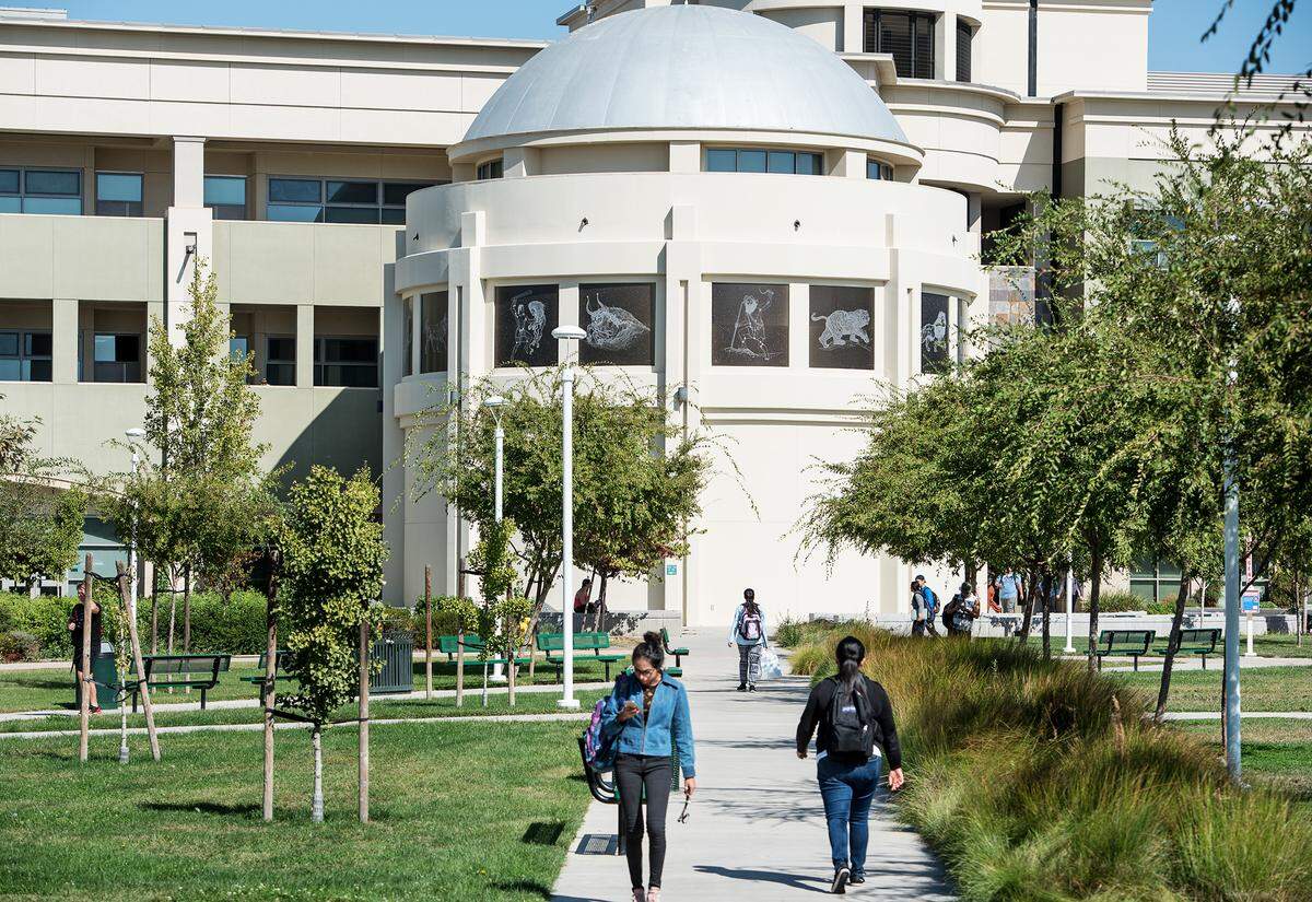 Modesto Junior college students walk outside the Science Community Building in Modesto, Calif., on Wednesday, Oct. 10, 2018.
