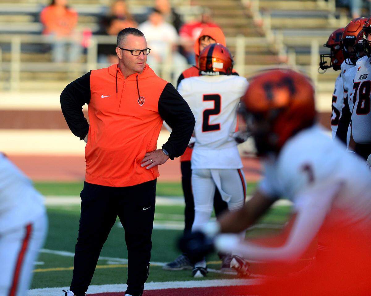 Merced head coach Rob Scheidt watches his team warm up before a game between Patterson High School and Merced High School at Patterson High on Aug. 23, 2024.