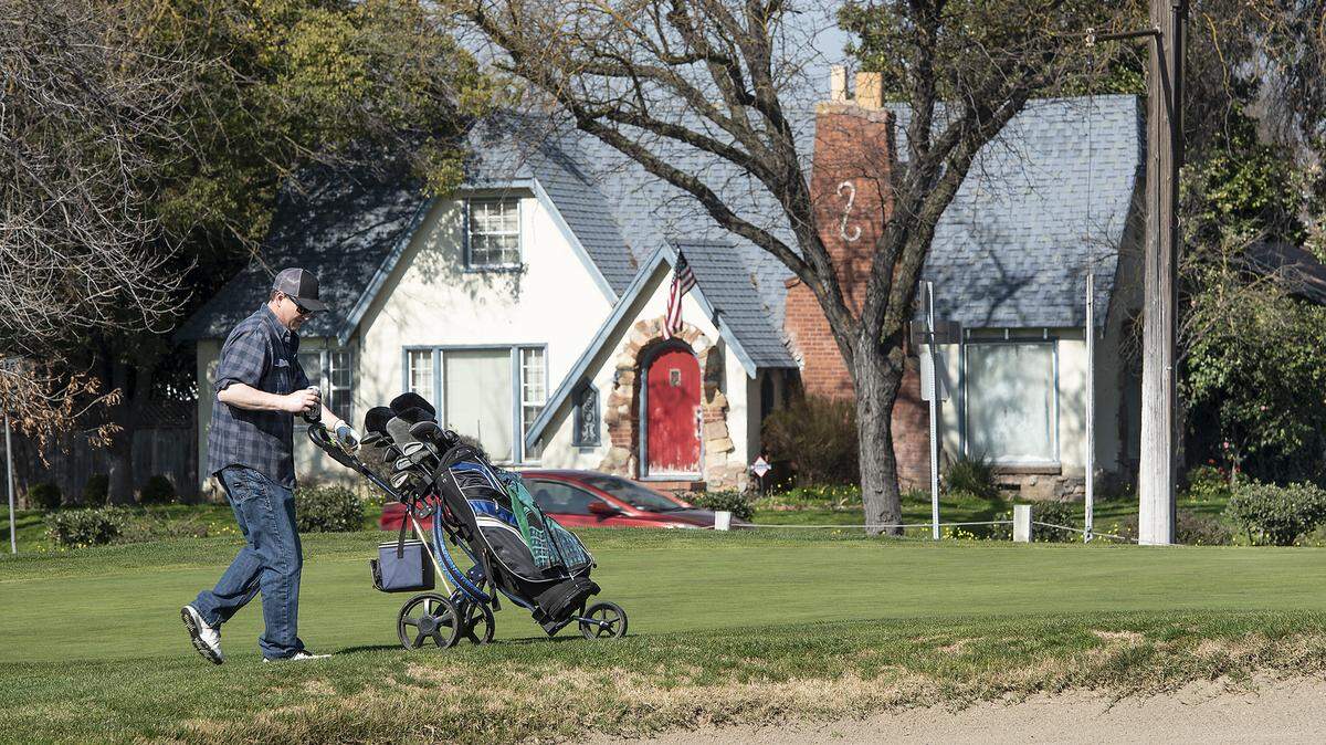 Brandon Fahlenkamp, left, walks to the 6th green at the Modesto Municipal Golf Course in Modesto, Calif., on Saturday, Feb. 8, 2020.