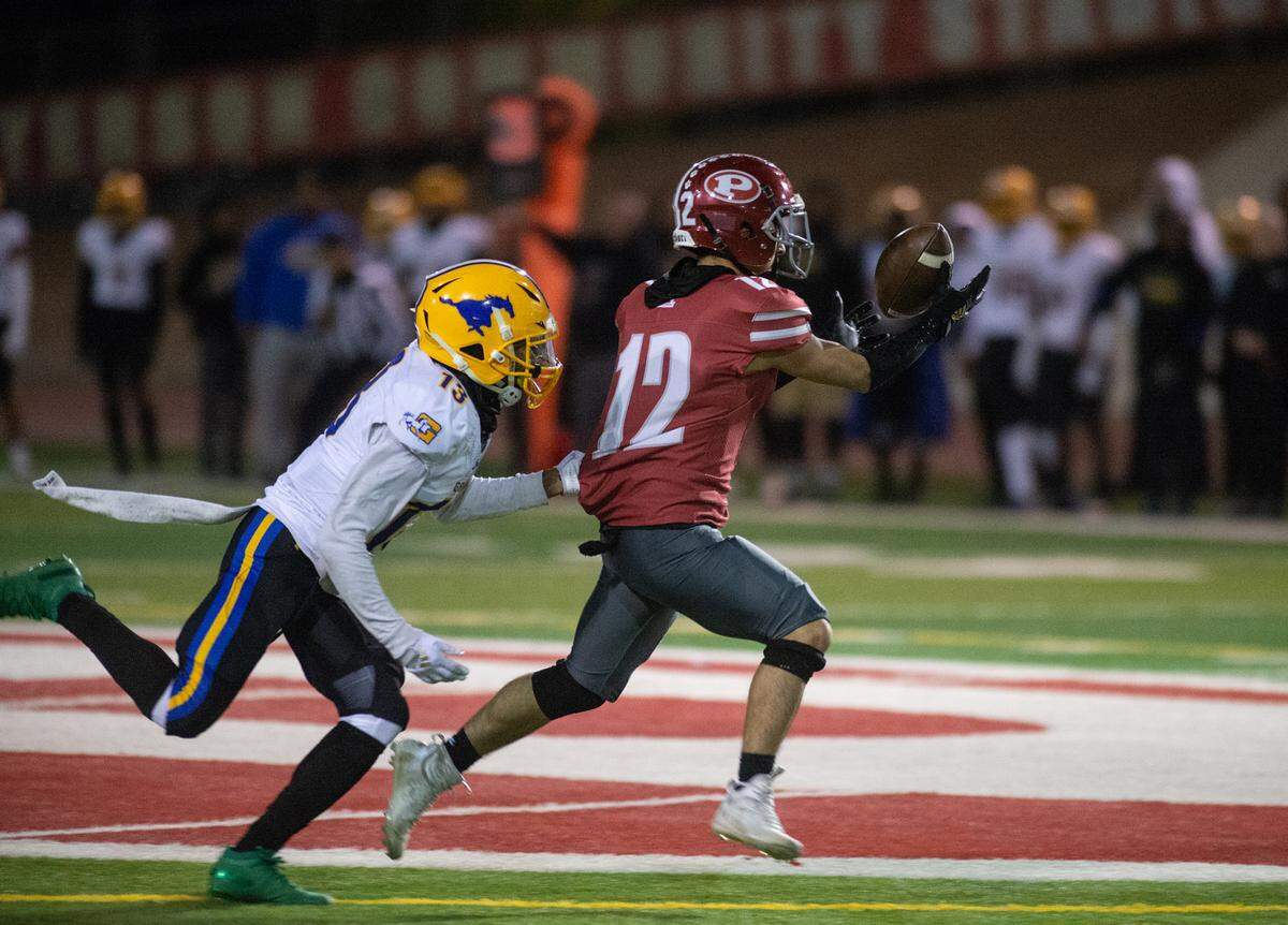 Patterson’s Nicholas Hernandez reaches out for a catch past Grant’s Jonah Ardoin during a Sac-Joaquin Section Division III semifinal in Patterson, Calif., Friday, Nov. 18, 2022. Grant won 80-44.