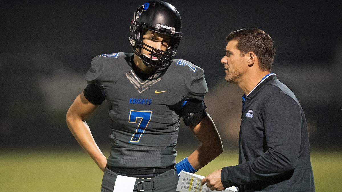 Offensive coordinator Randy Fasani talks with quarterback Cade Alger during the Sac-Joaquin Section Division VI playoff game with Waterford at Ripon Christian High School in Ripon, Calif., Friday, Nov. 9, 2018.