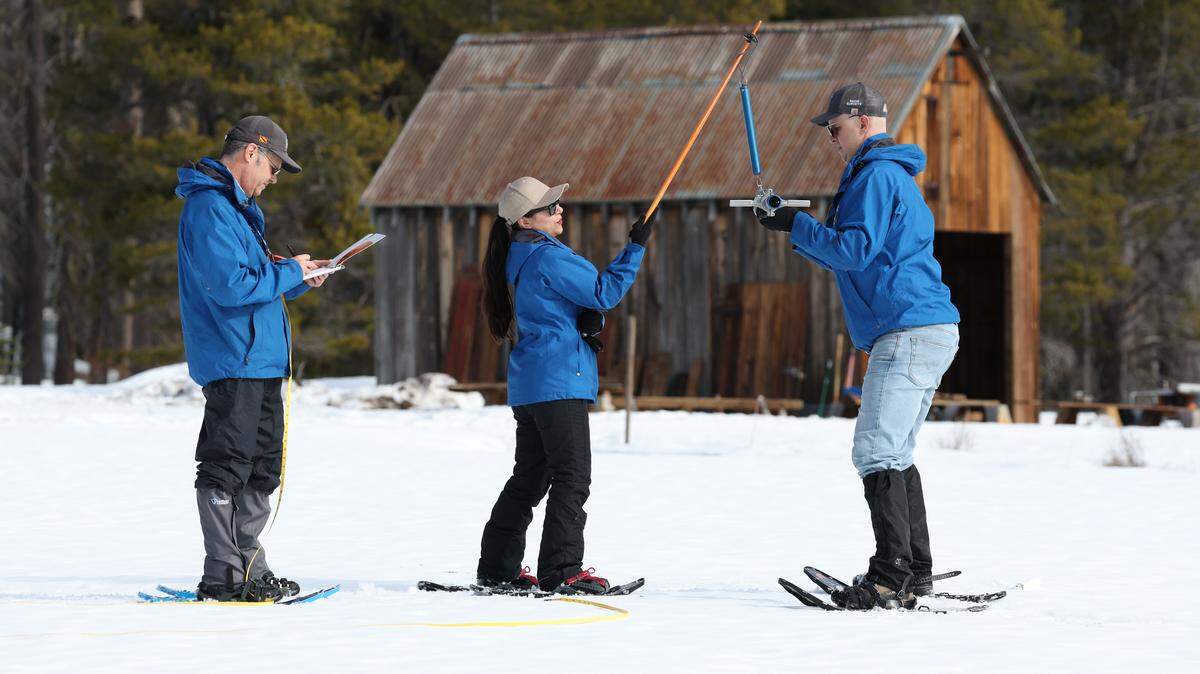 California Department of Water Resources (from right) Engineer Jacob Kollen, Hydrometerologist Angelique Fabbiani-Leon and Snow Survey and Water Supply Forecasting Unit Manager Andy Reising take measurements during the second media snow survey of the 2026 season at Phillips Station in the Sierra Nevada. The snow survey is held approximately 90 miles east of Sacramento off Highway 50 in El Dorado County. Photo taken January 30, 2026. 

Andrew Nixon / California Department of Water Resources