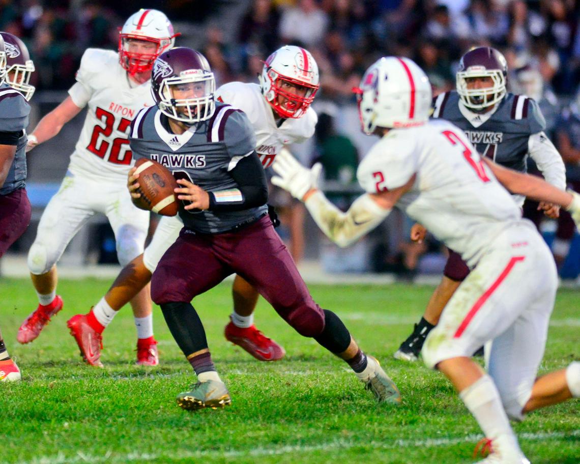 Central Valley quarterback Andrew Hernandez scrambles out of the pocket during a game between Ripon High School and Central Valley High School at Ceres High School in Ceres California on September 6, 2019.