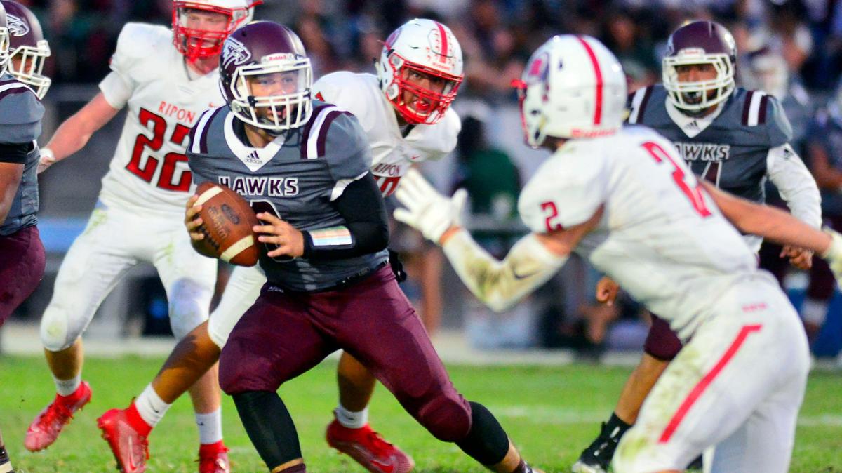 Central Valley quarterback Andrew Hernandez scrambles out of the pocket during a game between Ripon High School and Central Valley High School at Ceres High School in Ceres California on September 6, 2019.