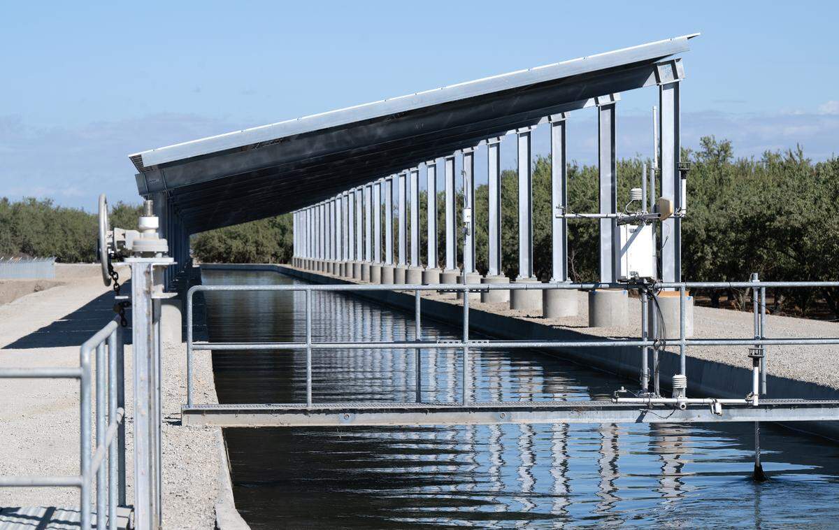 UC Merced monitoring equipment is mounted on a walkway as part of Project Nexus, a Turlock Irrigation District pilot project using solar arrays to cover irrigation canals, is under construction southwest of Keyes, Thursday, Oct. 17, 2024. UC Merced researchers are measuring the amount of evaporation in the covered section of the canal.