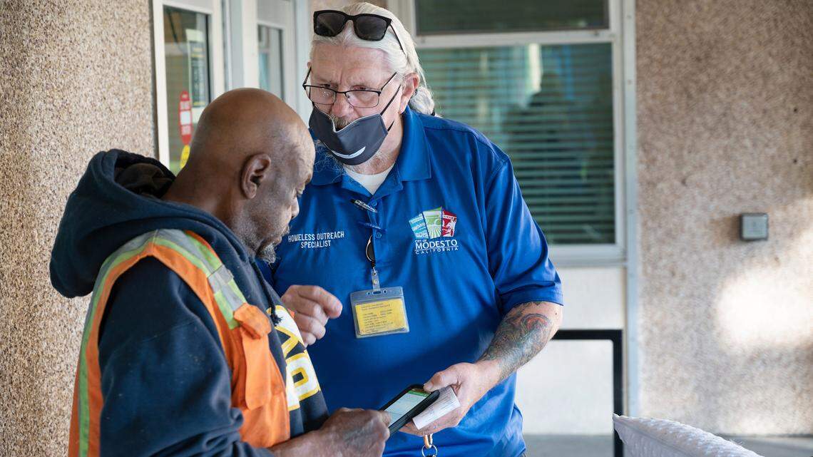 Community Health and Assistance Team outreach specialist Randy Limburg talks with a man outside the King-Kennedy Memorial Center in Modesto in 2021. Limburg died Wednesday.