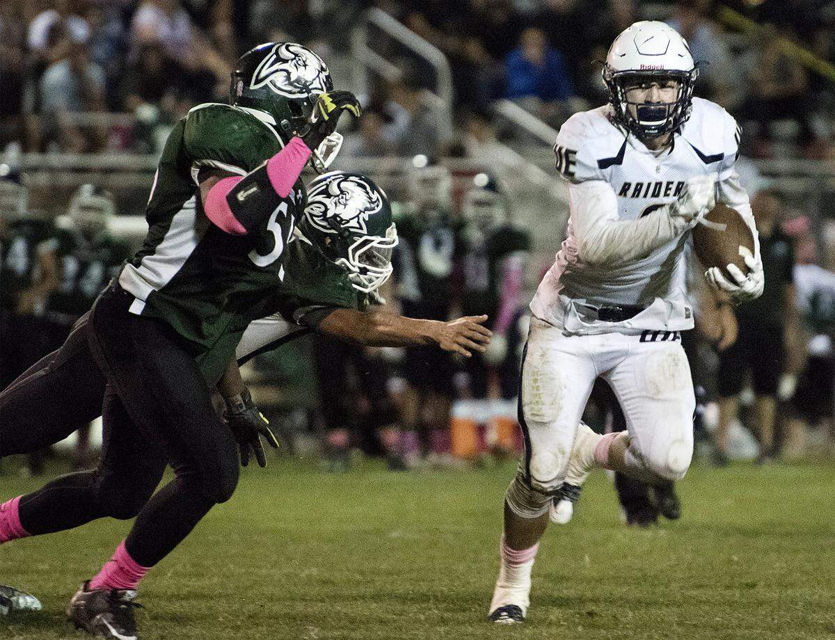 Central Catholic's Justin Rice evades the Manteca defense during the Valley Oak League game at Manteca High School in Manteca, Calif., on Friday, October, 16, 2015. Central Catholic won the game 28-6.