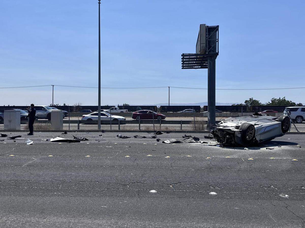 A Chevrolet Corvette lies upside down on Sisk Road in Modesto after crashing during a race on Highway 99.