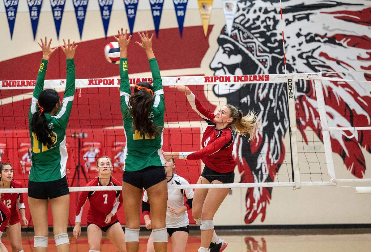 Ripon’s Kylee Fullmer (9) hits crosscourt past Tracy defenders during a non-league match in Ripon, Calif., on Thursday, September 22, 2022. Tracy won the match 3-2.