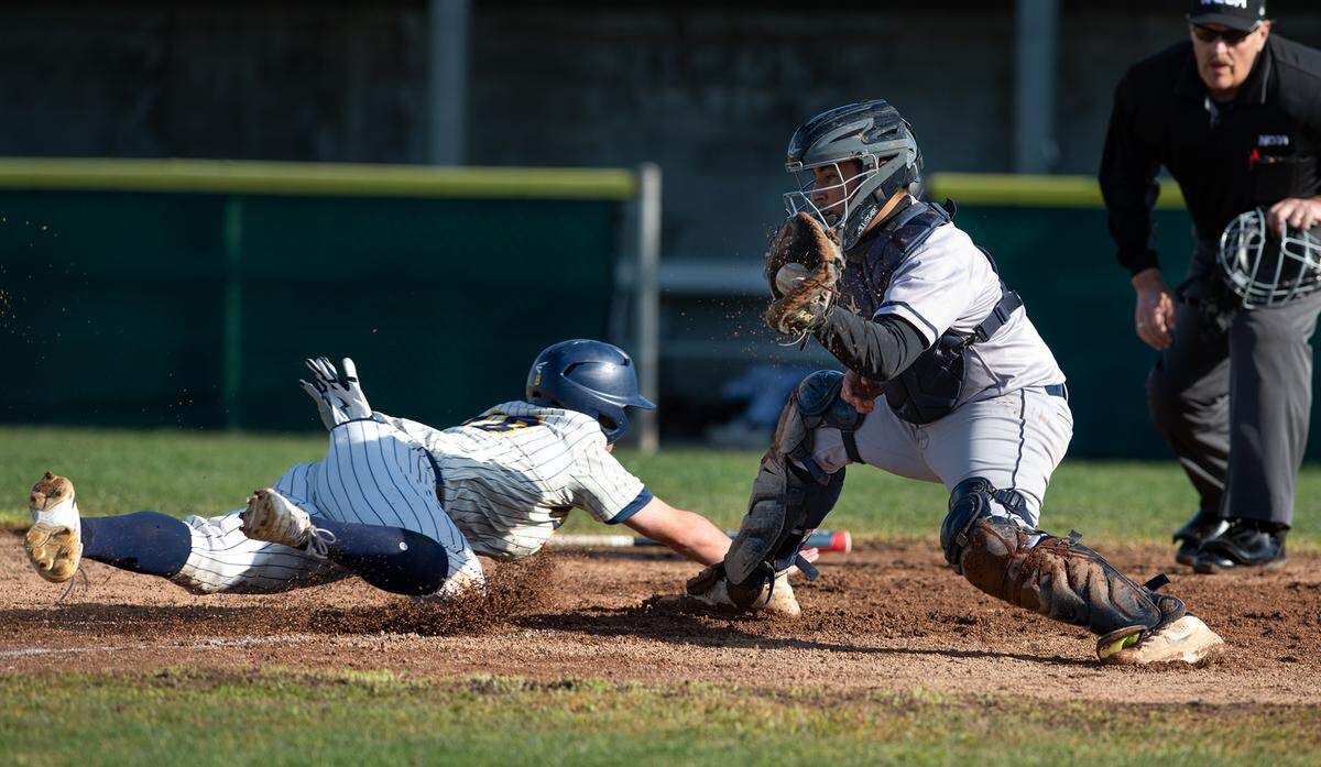 Gregori’s Lance Eastman beats the tag from Central Catholic catcher Fernando Alaniz during the non-league game at Gregori High School in Salida, Calif., Wednesday, March 15, 2023. Gregori won the game 11-1.