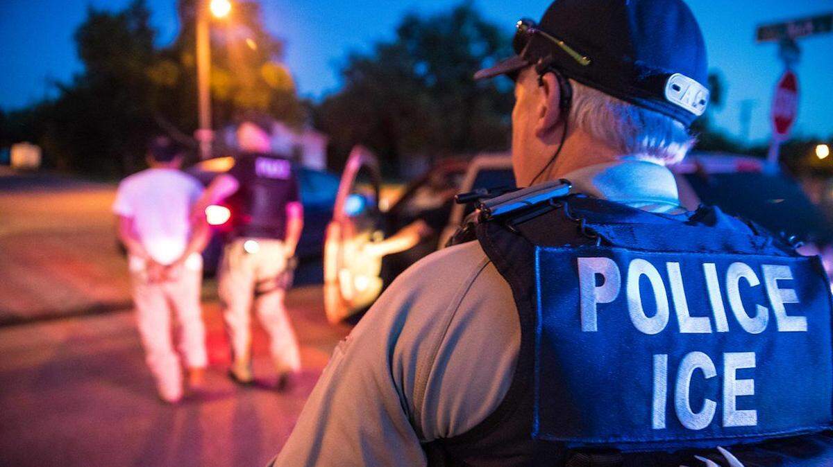 In this undated photo, a U.S. Immigration and Customs Enforcement officer observes a detainment.