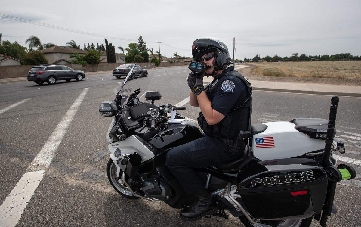 Modesto Police officer Ryan Olson, checks motorists’ speed on Pelandale Road in Modesto, Calif., on Thursday, May 5, 2022.