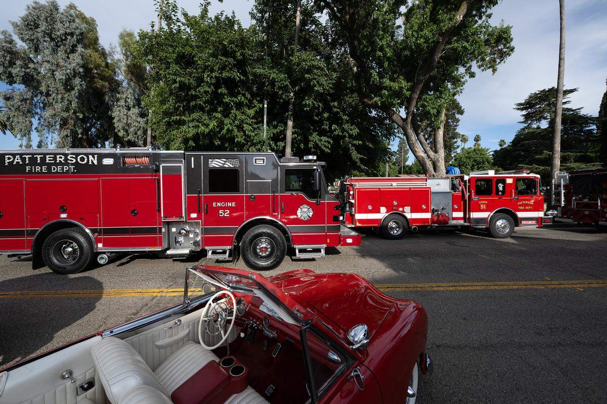 The Patterson Fire Department shows off its new fire engine, left, during National Night Out at North Park in Patterson, Calif., Tuesday, Aug. 1, 2023.