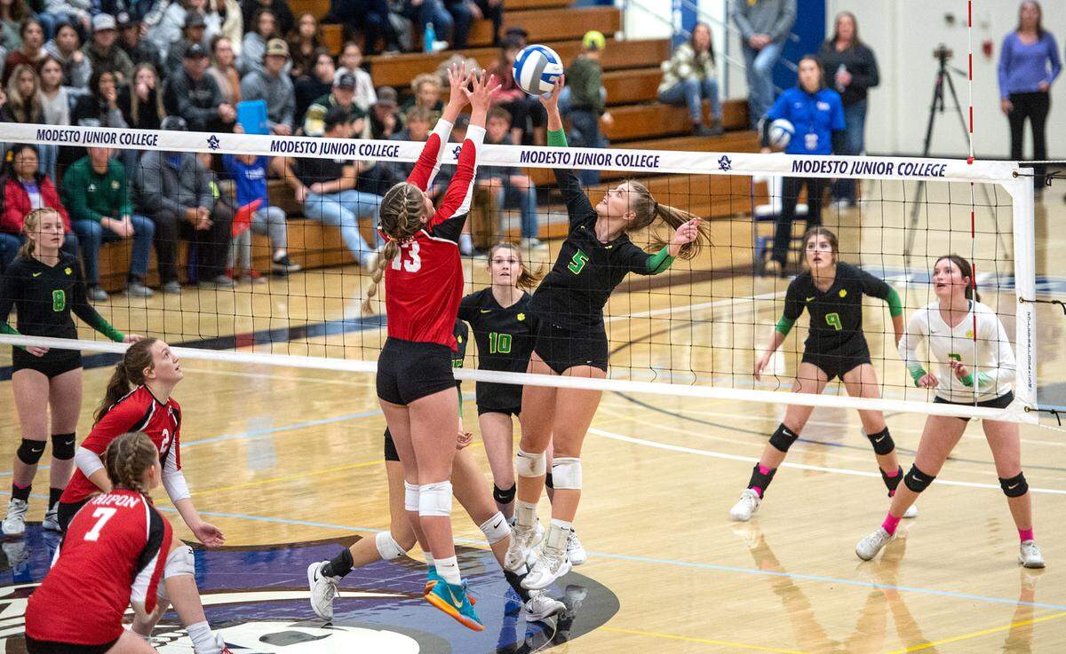 Sonora’s Paige Tipton (5) tips the ball past Ripon’s Adriana Dorn (13) during the Sac-Joaquin Section Division 4 Section final at Modesto Junior College in Modesto, Calif., Saturday, Nov. 5, 2022. Ripon won the title 3-1.
