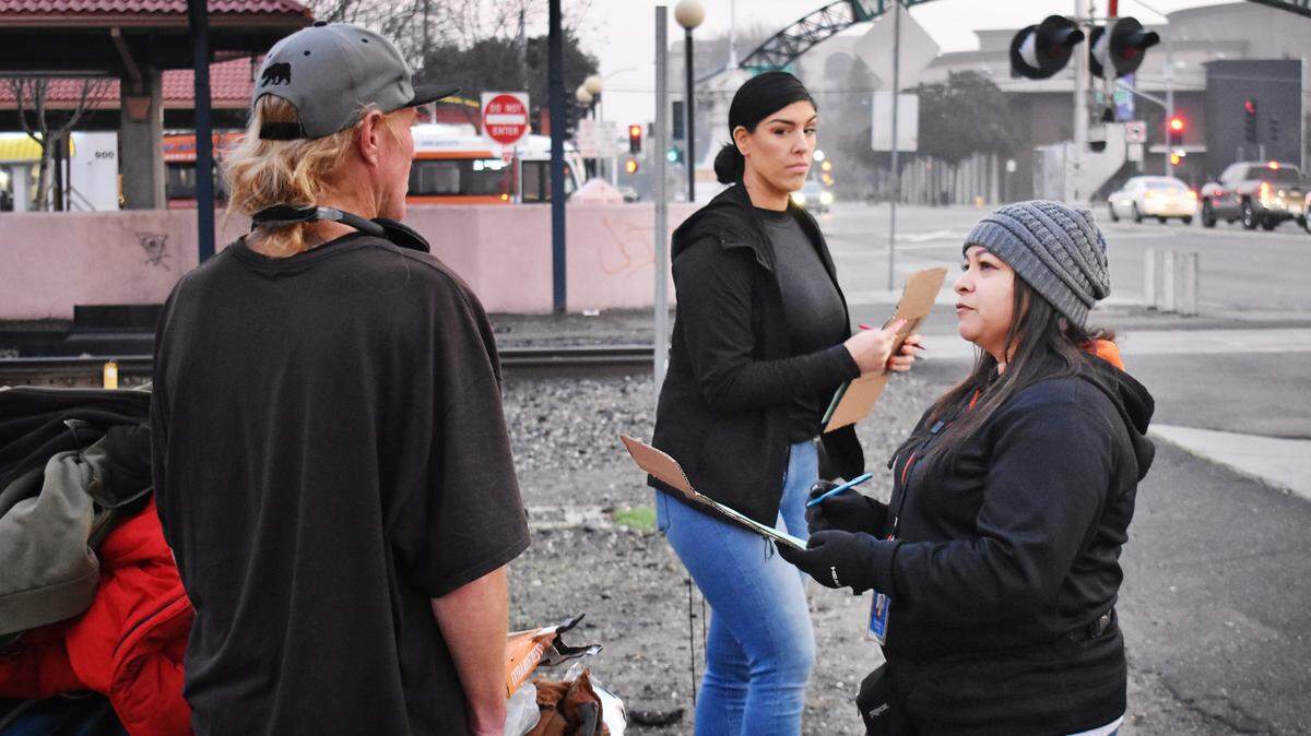 Bernice Acosta, right, and Nicole Cirrincione, center, help conduct the Stanislaus County point-in-time count of the homeless in downtown Modesto on Thursday morning, Jan. 23, 2020.