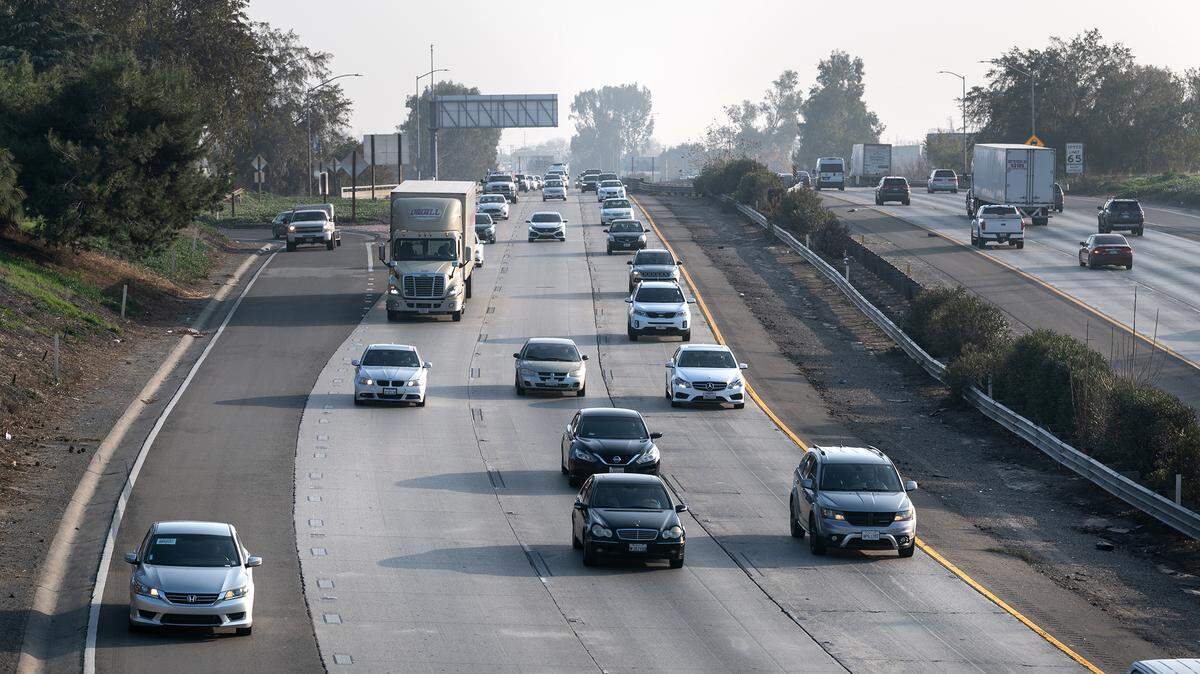 Motorists pass through Downtown Modesto, Calif., Tuesday, Dec. 20, 2022.