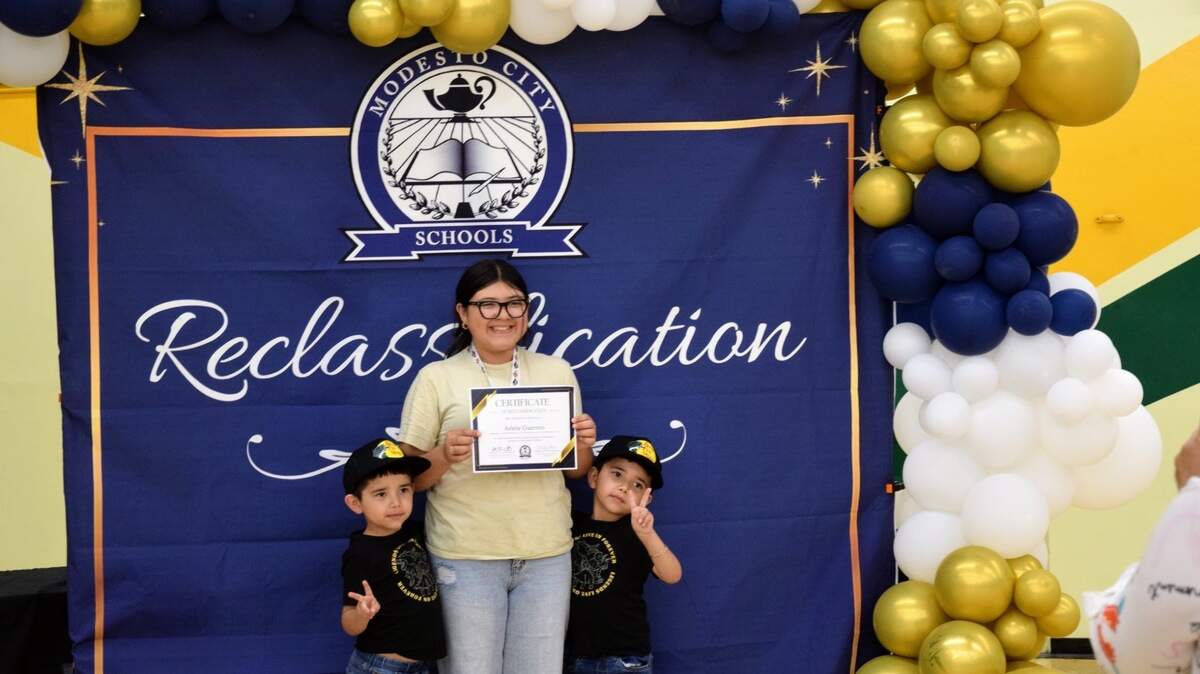 Arlene Guerrero, a seventh-grader at Hanshaw Middle School, holds her certificate at the Reclassification Celebration event at Davis High School on May 6, 2025.