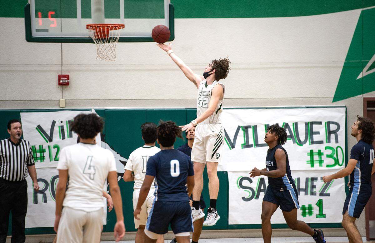 Pitman’s Robert Salmon (32) scores past Downey defenders during the Central California Athletic League game at Pitman High School in Turlock, Calif., on Friday, Feb. 4, 2022. Downey won the game 56-52.