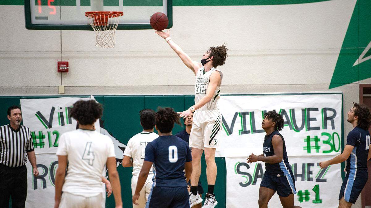Pitman’s Robert Salmon (32) scores past Downey defenders during the Central California Athletic League game at Pitman High School in Turlock, Calif., on Friday, Feb. 4, 2022. Downey won the game 56-52.